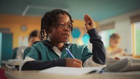 Talented Small African American Boy Asking Teacher a Question in Class. Portrait of a Happy Elementary School Student Studying Hard, Learning New Things, Getting Modern Education with Other Kids - Powered by Shutterstock - Get 15% off with code: PIKWIZARD15
