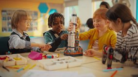 Elementary School Students Sitting Behind a Table in a Group, Building a Space Rocket Model for a Science and Technology Fair. Young Boys and Girls Wish to Become Engineers and Space Explorers - Powered by Shutterstock - Get 15% off with code: PIKWIZARD15