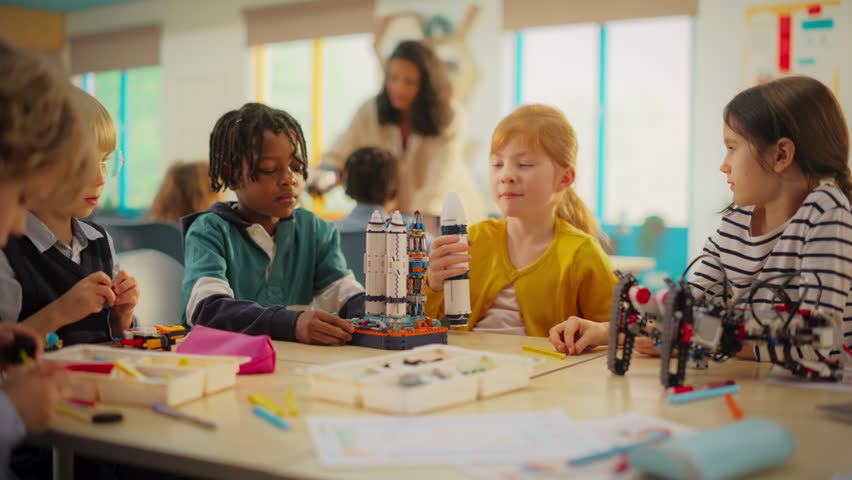 Team of Kids Finishing a Science Project and Celebrating with High Five. Talented Boys and Girls Created a Spaceship Model. Primary School Classroom with Children Working on Futuristic Technology Royalty-Free Stock Footage #3419492373