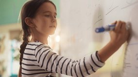 Talented Small Girl Solving an Arithmetic Equation that a Teacher Gave Her. Portrait of a Happy Elementary School Pupil Studying Hard, Writing a Correct Answer on a Whiteboard During a Math Test - Powered by Shutterstock - Get 15% off with code: PIKWIZARD15