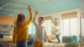 Portrait of Two Cute Caucasian Girls Solving a Mathematical Task on a Whiteboard in Class in a Modern Elementary School. Young Talented Pupils Celebrate with a High Five - Powered by Shutterstock - Get 15% off with code: PIKWIZARD15