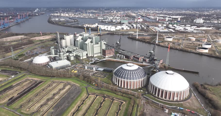 Electricity generation through Fossil fuels, coal fired power plant in the port of Hamburg, Germany. Birds eye aerial drone view.