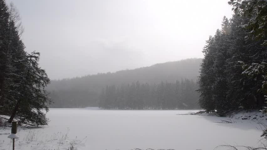 Bradford Pennsylvania USA January 16 2024: Marilla reservoir Stunning winter day frozen lake pine trees covered in snow hiking trails and roads.