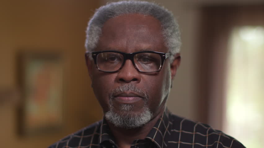 An elderly African American male, sad or feeling depression, looking at camera in close up authentic portrait. Royalty-Free Stock Footage #34198705