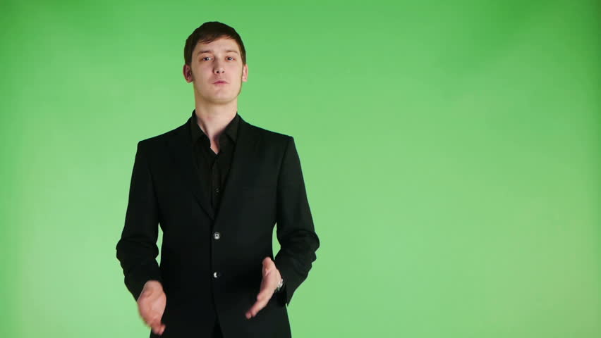 young businessman making a presentation on green background