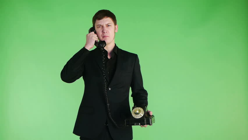 businessman talking on old phone angry