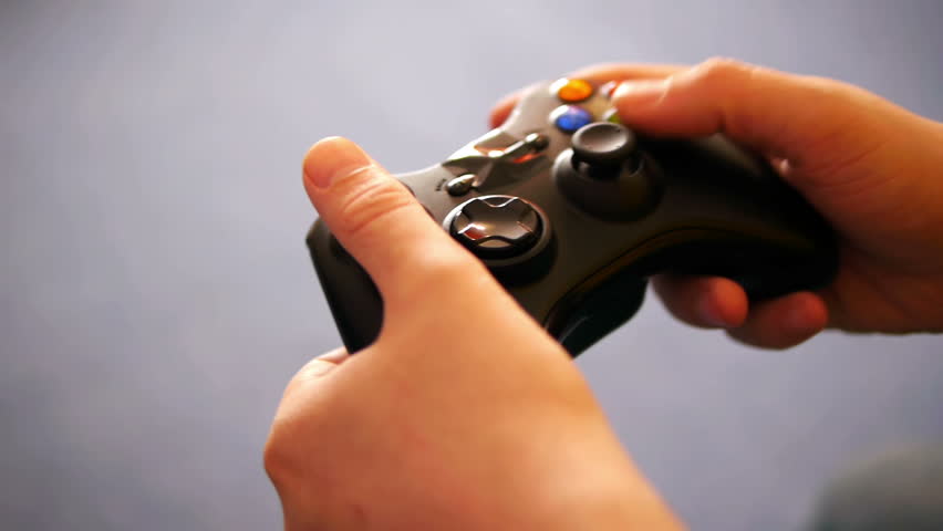 hands of an adult man playing video game close-up