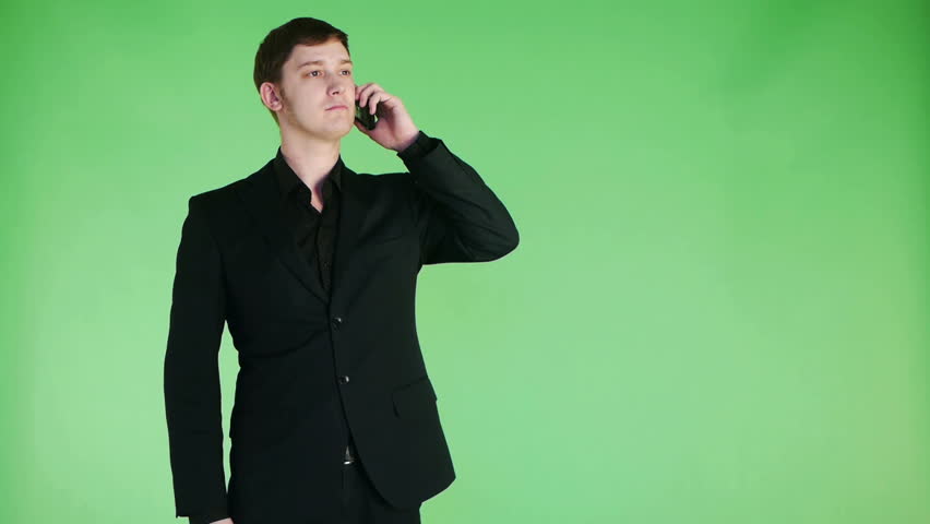 cheerful young businessman talking on phone and smiling