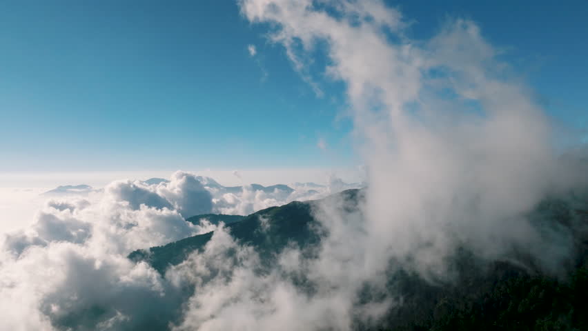 Aerial view of clouds around mountain peaks