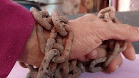 The chain was so old that it was rusted and brown. It was wrapped around my hand and my hand was trying to pull and pull it free.
