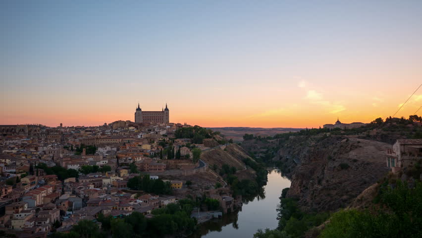 Toledo, Spain old town cityscape at the Alcazar. 4K timelapse video at sunrise time with zooming in camera motion.