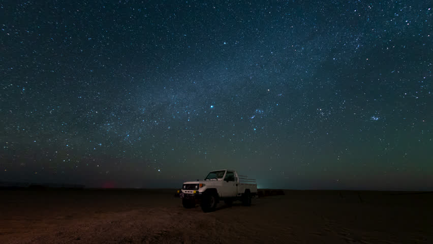Time lapse of night Stars motion with Gemini Meteors shooting in safari desert camping camel farm Bedouin