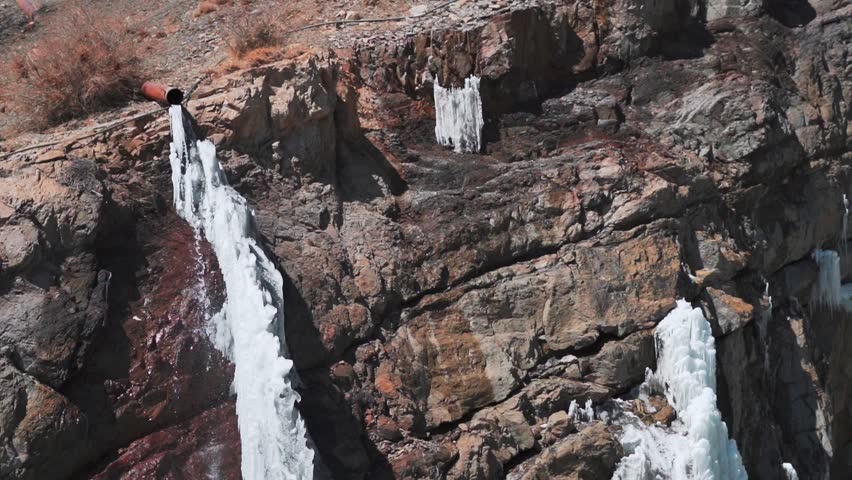 Closeup shot of frozen Lingti waterfall as seen on the way to Kaza at Spiti Valley in Himachal Pradesh, India. Frozen waterfall during the winter season at Spiti in India. Natural background.  Royalty-Free Stock Footage #3420097465