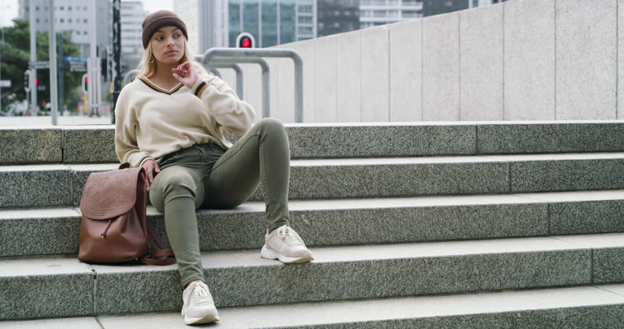 City, fashion and portrait of woman on stairs with backpack, gen z and streetwear on campus. Morning, buildings and urban clothes, college girl relax on street with bag, concrete steps and cool style