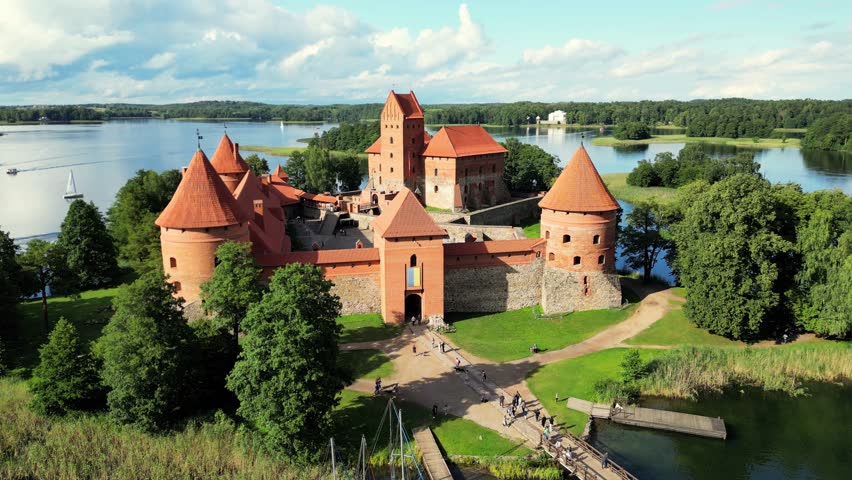 Trakai castle: medieval gothic Island castle, located in Galve lake, Lithuania. Trakai castle at summer, aerial view above the castle. Most beautiful and popular tourist Lithuanian landmark. Royalty-Free Stock Footage #3420230265