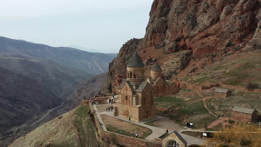 A medieval stone monastery in the mountains. Aerial view church in Armenia. Drone fly from Ancient church, monastery․ Tourists near monastery. Famous touristic place. Royalty-Free Stock Footage #3420251675