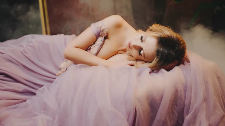 Fairy tale lady queen evening gown old style in dream eyes closed. beauty face Princess girl lies sleeping in a royal lush long skirt purple dress. Sexy Fantasy woman sleeping beauty art portrait 4k
