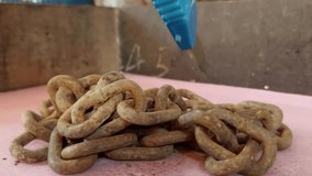 A chain so old it had rusted brown, it was wrapped around his hand and cut with a cutter.