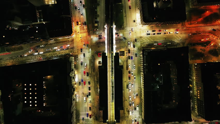 Birds eye shot of traffic in evening metropolis. Busy multilane thoroughfare with elevated Ubahn tracks in middle. Vienna, Austria
