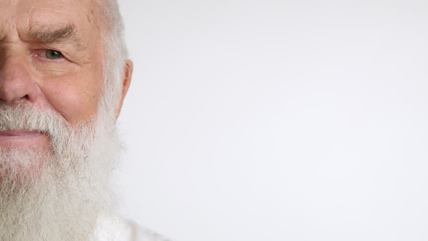 Close-up of a confident senior man with a white beard looking directly at the camera, perfect for commercial and advertising purposes, with ample copy space on a clean white background. Camera 8K RAW.