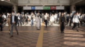 Slowmotion and blurred defocused view of a commuters exiting the metro station in Japan, rushing to get to their workplaces. A bustling crowd of people march down the busy street - Powered by Shutterstock - Get 15% off with code: PIKWIZARD15