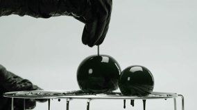 Woman chef confectioner pouring caramel on mousse pink cake, creamy dessert close-up gastro art. Restaurant dessert, Honey biscuits, confit, almond chocolate mousse made with honey and lime zest.  - Powered by Shutterstock - Get 15% off with code: PIKWIZARD15