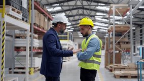 Supervisor, manager scolding employee in modern industry factory. Worker making mistake. Production manger is angry, dissatisfied for worker's poor quality work, safety viaolations. - Powered by Shutterstock - Get 15% off with code: PIKWIZARD15