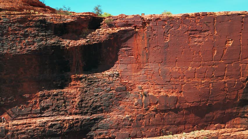 Aerial panning footage of large rock faces at Kings Canyon, Australia