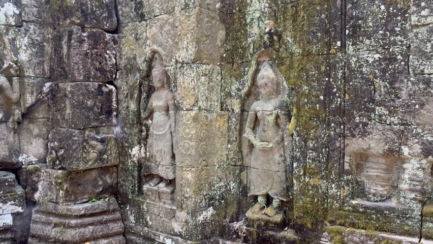 Detail of the mural frescoes of the Buddhist temple Ta Som, built by Jayavarman VII in the late 12th century at the Angkor site in Cambodia. Check the gallery for similar footages. Royalty-Free Stock Footage #3420617245
