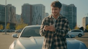 Caucasian successful man smiling client using smartphone outdoors happy male car driver businessman stand near new luxury auto in city surfing internet mobile phone application for electric automobile - Powered by Shutterstock - Get 15% off with code: PIKWIZARD15