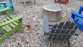 Outdoor chairs surrounding metal covered fire pit in social gathering area - Powered by Shutterstock - Get 15% off with code: PIKWIZARD15