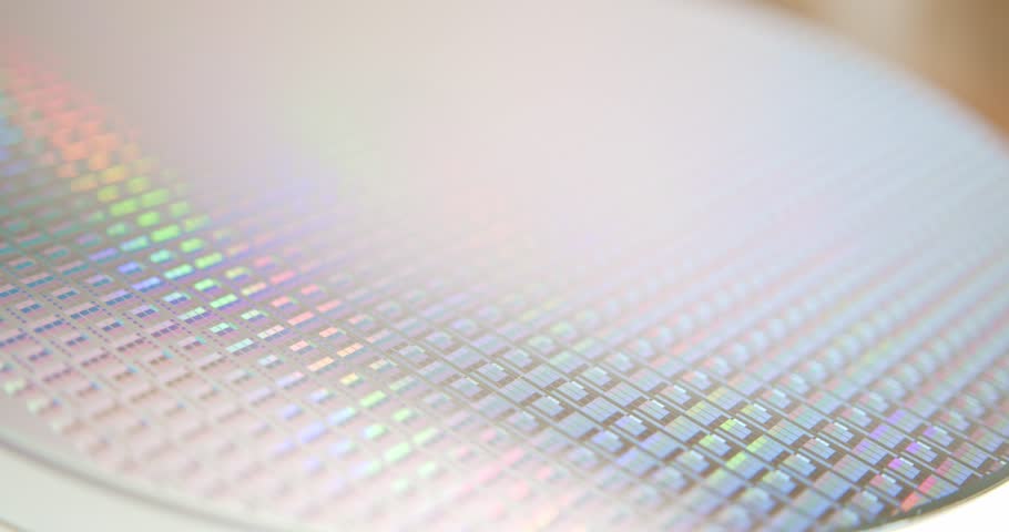 A pattern of microprocessor circuits on a silicon wafer. The semiconductors or central processing unit CPU microchips are fabricated from a silicon wafer with patterned layers of various materials.	 Royalty-Free Stock Footage #3420738961