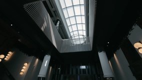 Modern Atrium Ceiling View. The view of a modern atrium ceiling with geometric patterns and natural light. - Powered by Shutterstock - Get 15% off with code: PIKWIZARD15