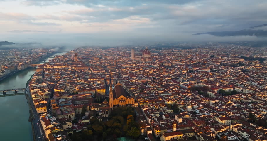 Aerial view of the Arno river cityscape in Florence, Italy. Bridges across the river in the beautiful architecture of the old historical European city. High quality 4k footage