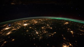 Planet Earth night view with illuminated cities seen from the International Space Station with Aurora Borealis over the earth in Sept 2011, Time Lapse 4K. Images courtesy of NASA Johnson Space Center