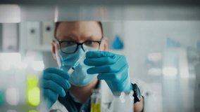 Medicine preparation process. The anesthesiologist wearing protective gloves carefully prepares the necessary medicine for anesthesia. An experienced medical specialist fills syringe with modern drug - Powered by Shutterstock - Get 15% off with code: PIKWIZARD15