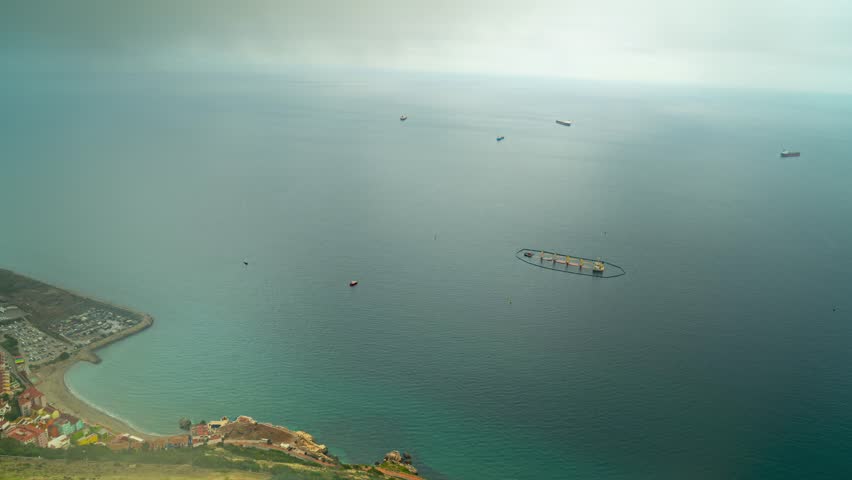 Floating farm and industrial port of Gibraltar coast, time lapse from above