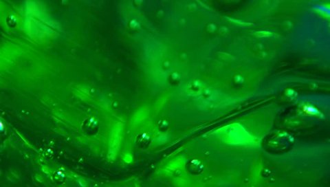 Extreme macro of bubbles in green jello cream (gel).