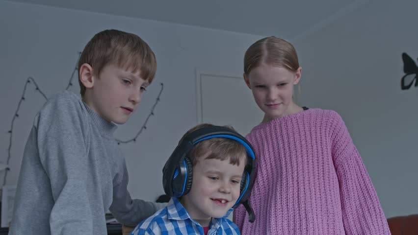 Three kids watching a show on a tablet Royalty-Free Stock Footage #3421056015
