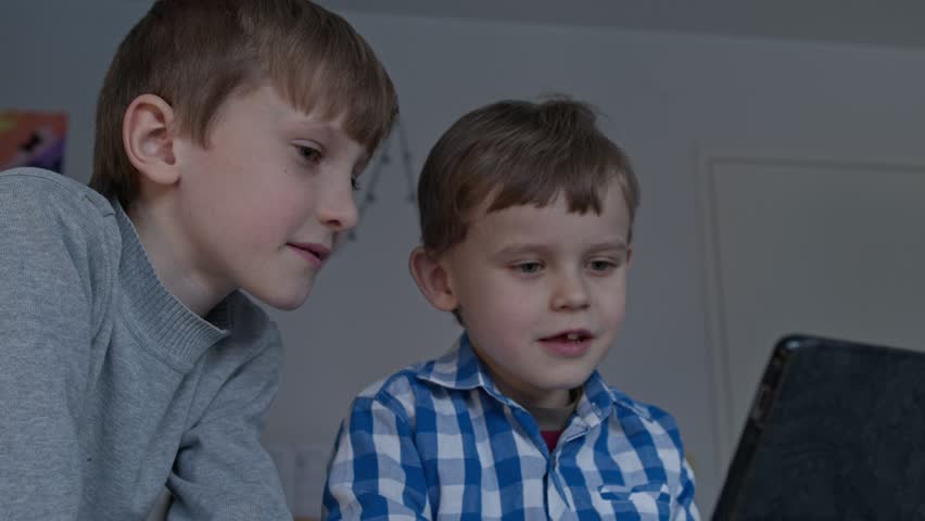 Two boys at the desktop using a tablet Royalty-Free Stock Footage #3421058049