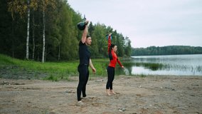 Sportsman And Sportswoman Training Outdoors, Athletic People Lifting Weights In Nature - Powered by Shutterstock - Get 15% off with code: PIKWIZARD15