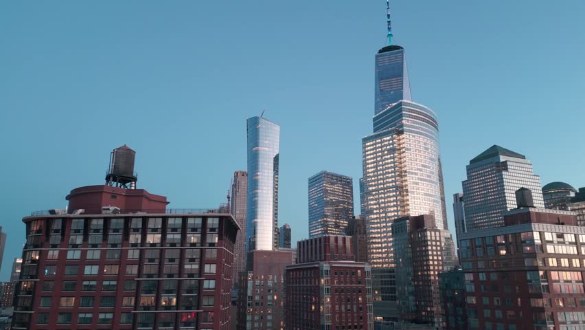Manhattan view from above twilight sky. Forwards fly above street between modern buildings. Day in Manhattan, NYC aerial view. New York City, Manhattan view from drone. NYC, Manhattan skyline, USA.
