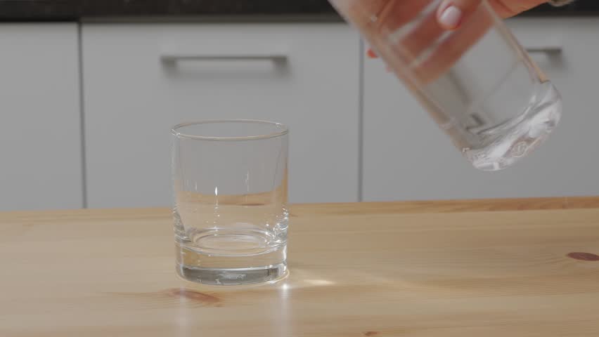 Pouring water into the glass of water. Safe drinking water is the basic condition for human health.