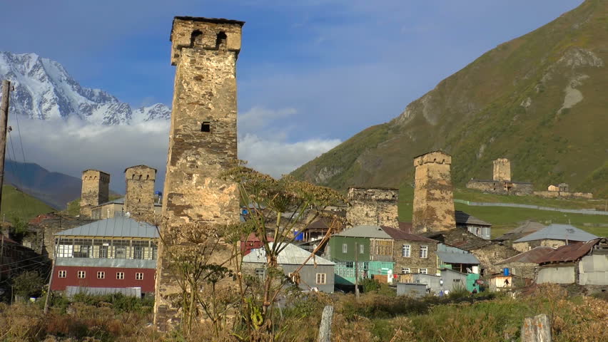 Svaneti Old village in Georgia. Medieval tower built for defensive purposes. Each family had its own tower. In the background a mountain river