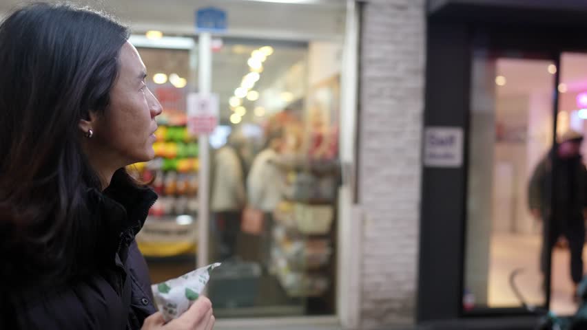 Slow-motion video of a Korean man in his 30s walking on the main street of Myeong-dong, Seoul, South Korea in the cold winter