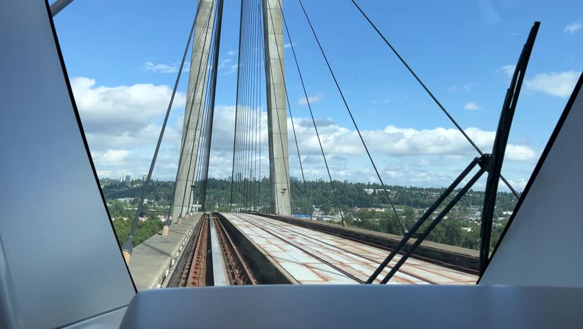 PATTULLO BRIDGE back window train on the bridge another blue train passes light traffic in big cities vancouver ordinary people work road comfort tourists canada vancouver 2023 Royalty-Free Stock Footage #3421402201