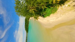 Vertical video. Cinematic FPV drone flight over tropical white sandy beach and turquoise sea on paradise island in Thailand.