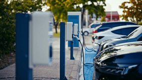 EV charging an electric car.Power supply for electric car charging. Socket for electric car battery charger. EV car charging station. Nature energy, Clean energy, Green eco concept. Plugging in cable. - Powered by Shutterstock - Get 15% off with code: PIKWIZARD15