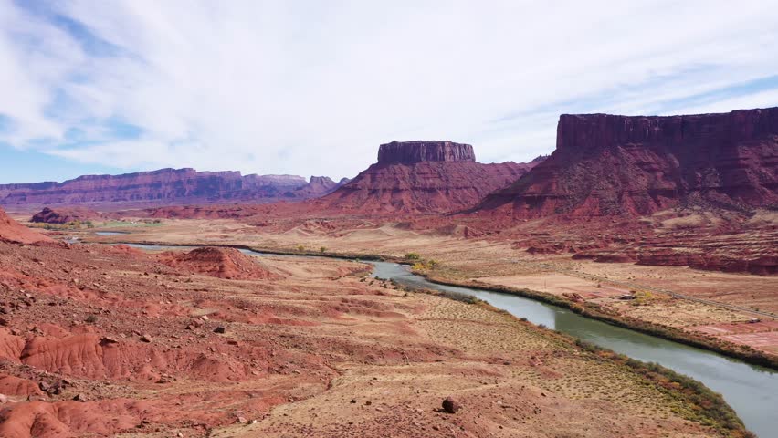 Desert valley of great colorado river with red orange canyon and big rocks butte massive. Red mountains and gorge, picturesque landscape western usa near Arches national park, aerial view nature