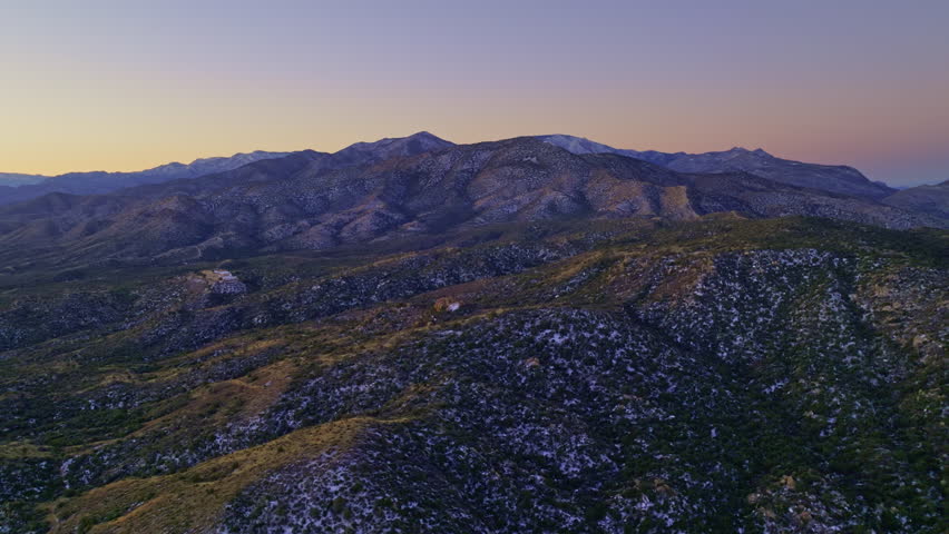 Drone footage flying over snowy Sonoran desert at sunrise